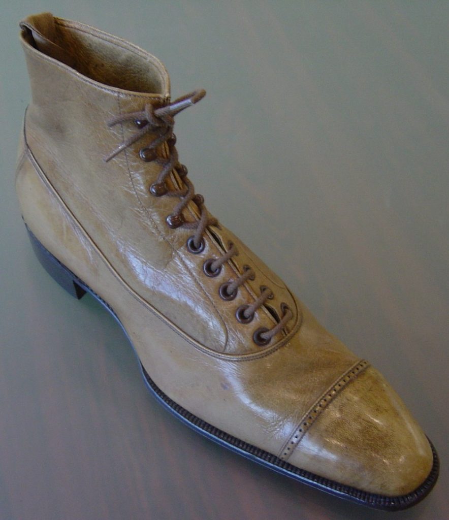 A cream-colored balmoral boot
